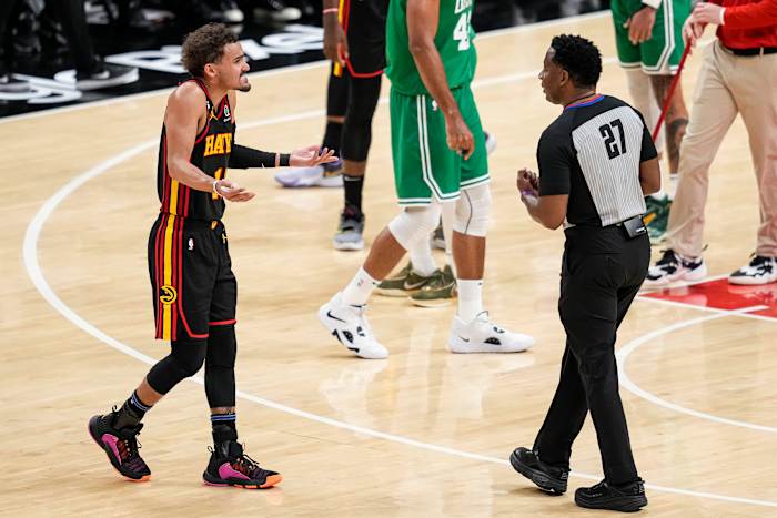 Atlanta Hawks guard Trae Young questions a referee during a timeout.